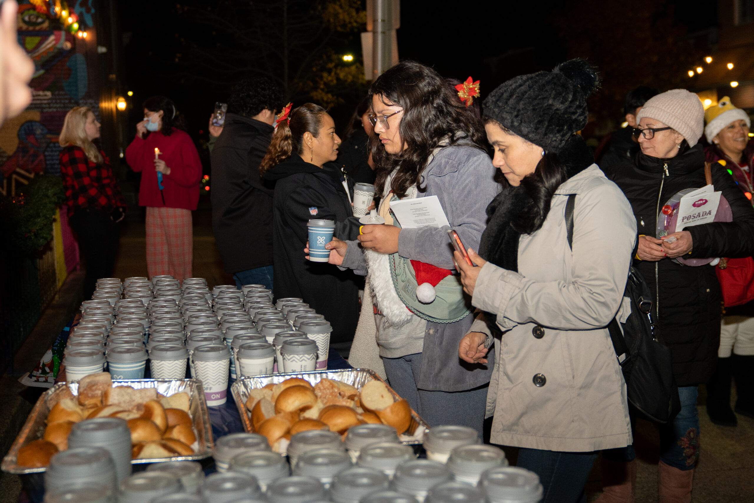 Hot chocolate and bread giveaway by Salem church during La Posada procession